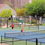 Adults playing tennis at the Plaza Tennis Center