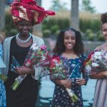 Girls Dressed up holding flowers in the park