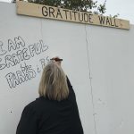 Lady Writing on Gratitude Wall